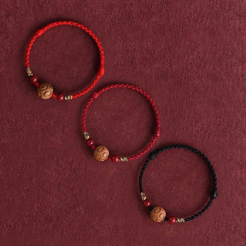 Armband Pfirsichholz Zinnober Glück geflochten rot schwarz Schutz Handgelenk