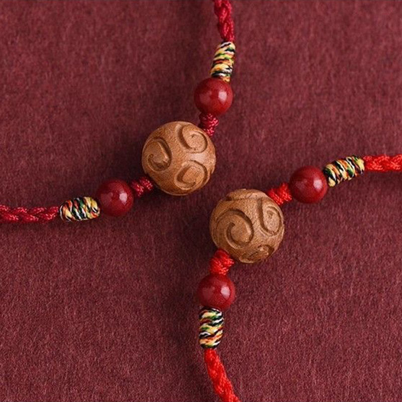 Armband Pfirsichholz Zinnober Glück geschnitzte Holzperle rote Kordel Schutz