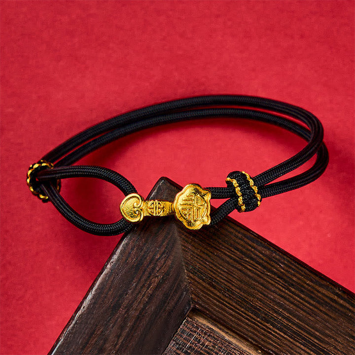 Armband Kupfer Fu-Zeichen Glück Energie schwarz geflochten auf Holz
