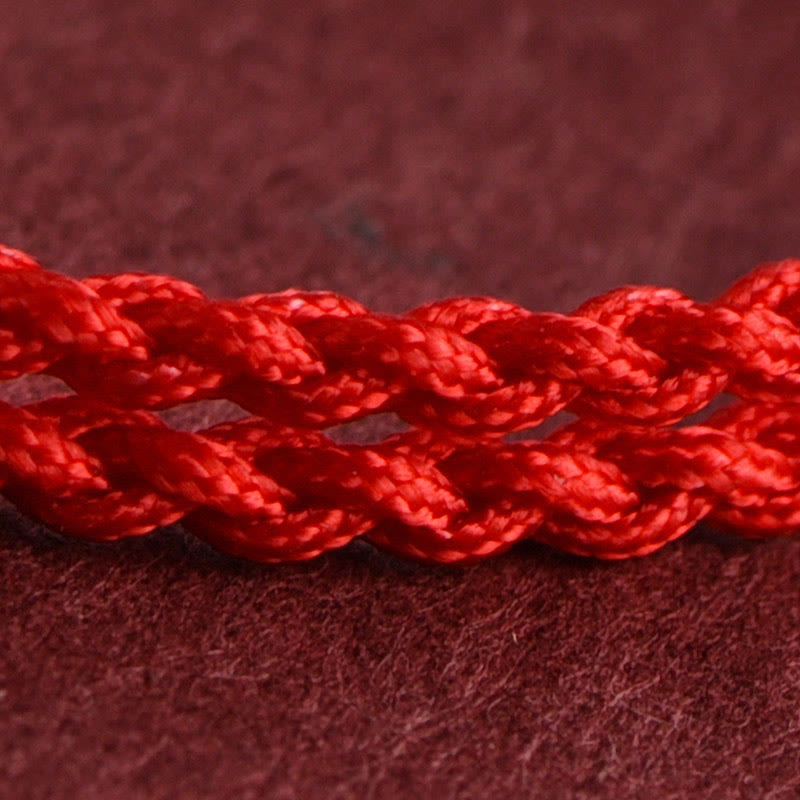 Armband Pfirsichholz – Glück & Wohlstand rote geflochtene Kordel Nahaufnahme Schutz