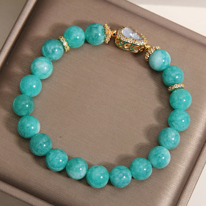 Armband Amazonit – Heilung & Selbstvertrauen mit goldenem Buddha-Anhänger in Schmuckschatulle