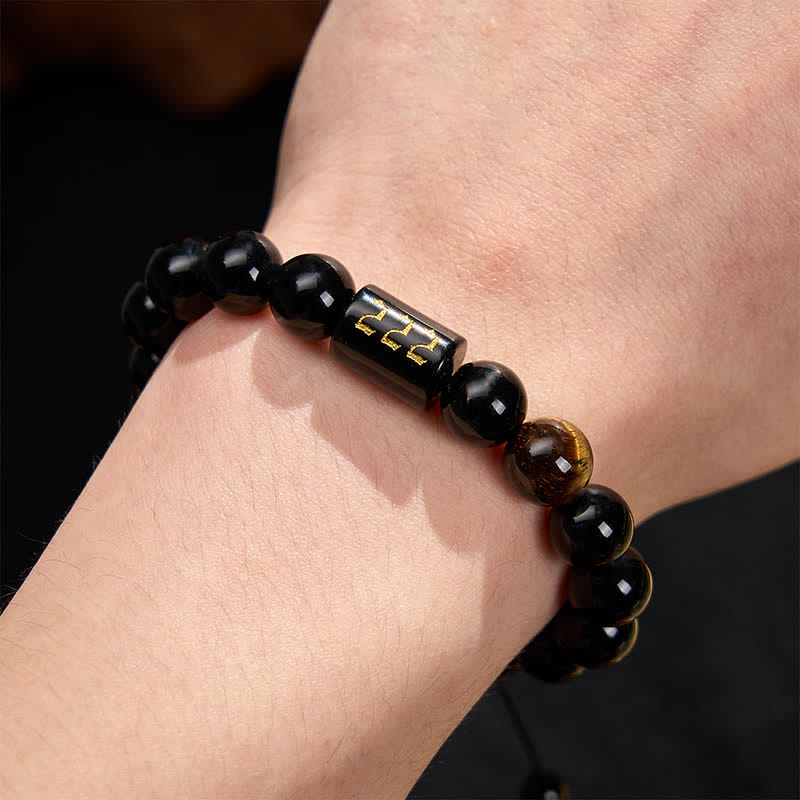 Armband Schwarzer Obsidian Tigerauge Stärke Segen am Handgelenk getragen Mantra