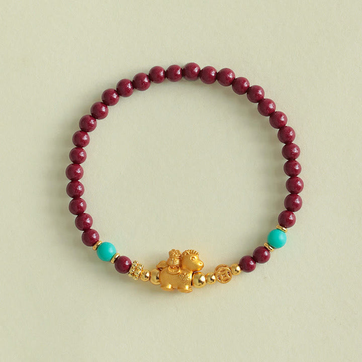 Armband Zinnober Fu-Zeichen Ruhe Energie Perlen Türkis goldenes Pferd