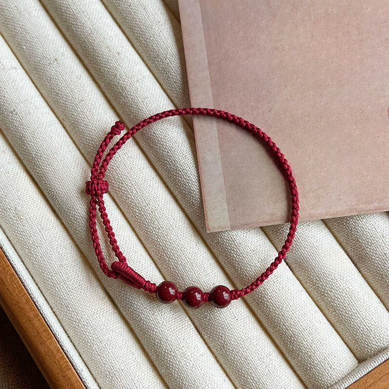Armband Zinnober – Segen & Ruhe rote Perlen geflochten Handgelenk Schutz