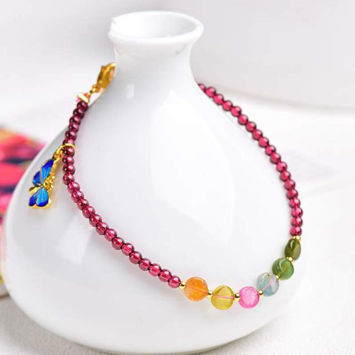 Armband Granat Schmetterling – Schutz bunter Kristallperlen goldene Akzente elegant.