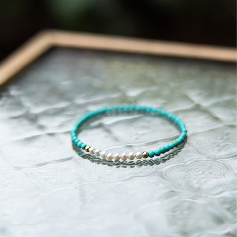 Türkis Armband 925 Silber mit Perlen elastisch auf Musteroberfläche