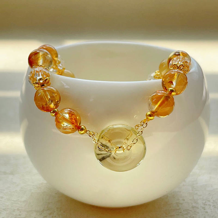 Armband Citrin Kristall Frieden Wohlstand goldene Perlen weiße Schale
