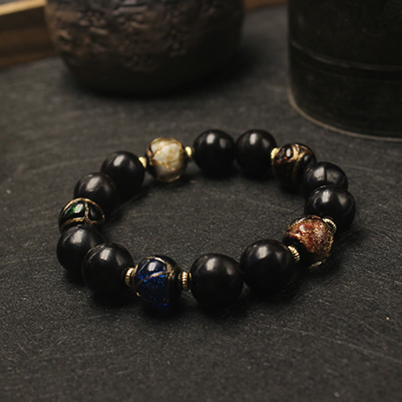 Armband – Wohlstand Harmonie schwarze Perlen Naturstein mit Akzenten elegant