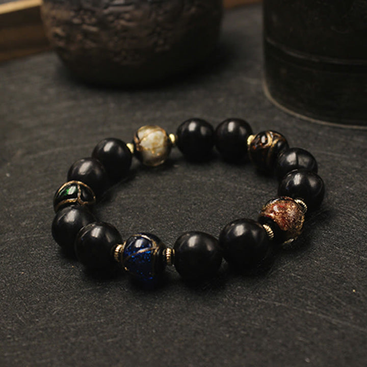 Armband – Wohlstand Harmonie schwarze Perlen Naturstein mit Akzenten elegant