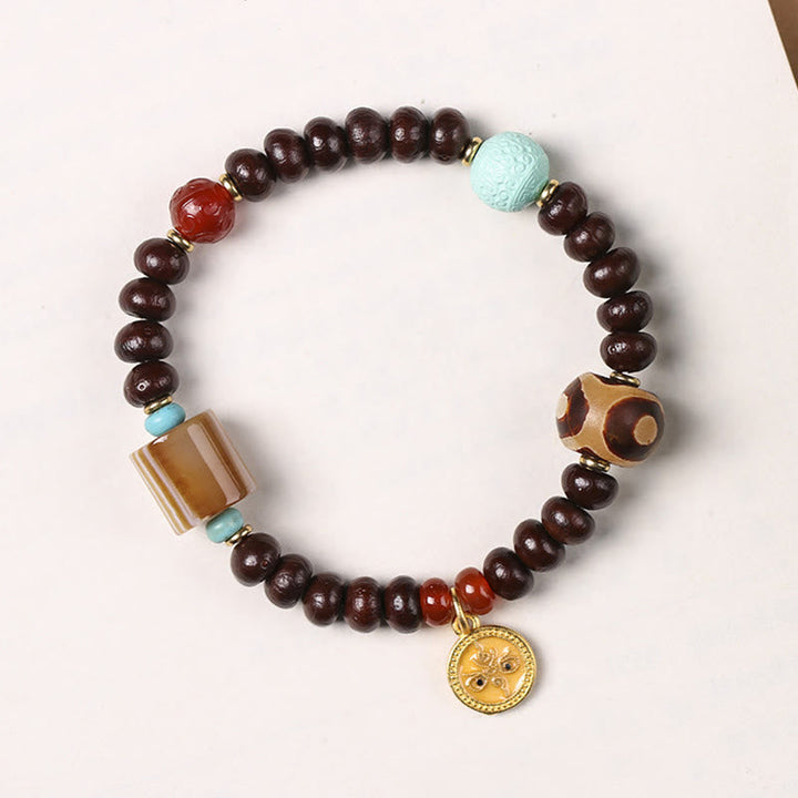 Bodhi Armband mit braunen Perlen Türkis Akzenten Goldmünze Anhänger