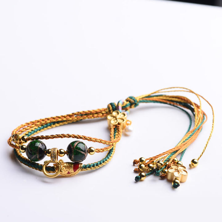 Armband – Heilung & Stärke grüner Stein goldene Schnur Tassel