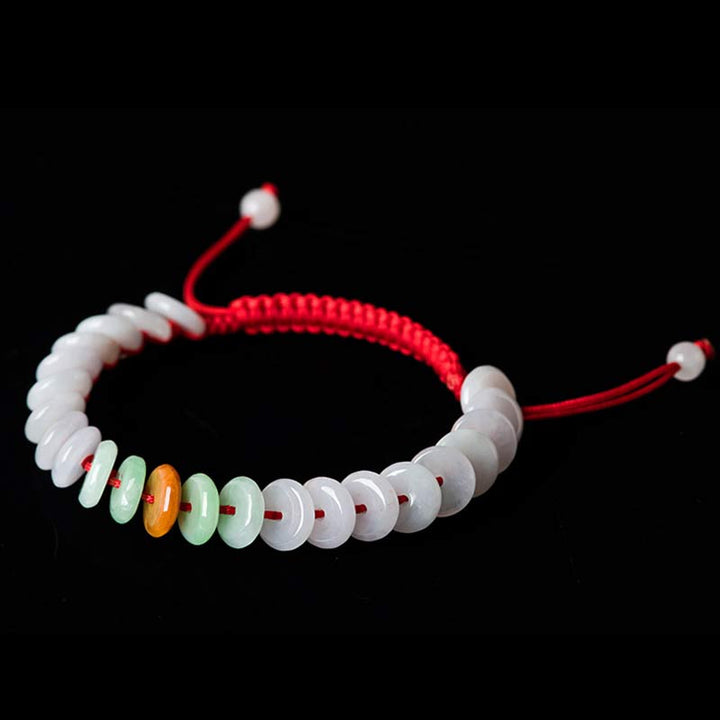Jade Armband mit roten Schnüren und grünen Steinen elastisch.