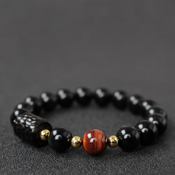 Schwarzer Obsidian Tigerauge Armband mit goldenen Akzenten elegantes Design.