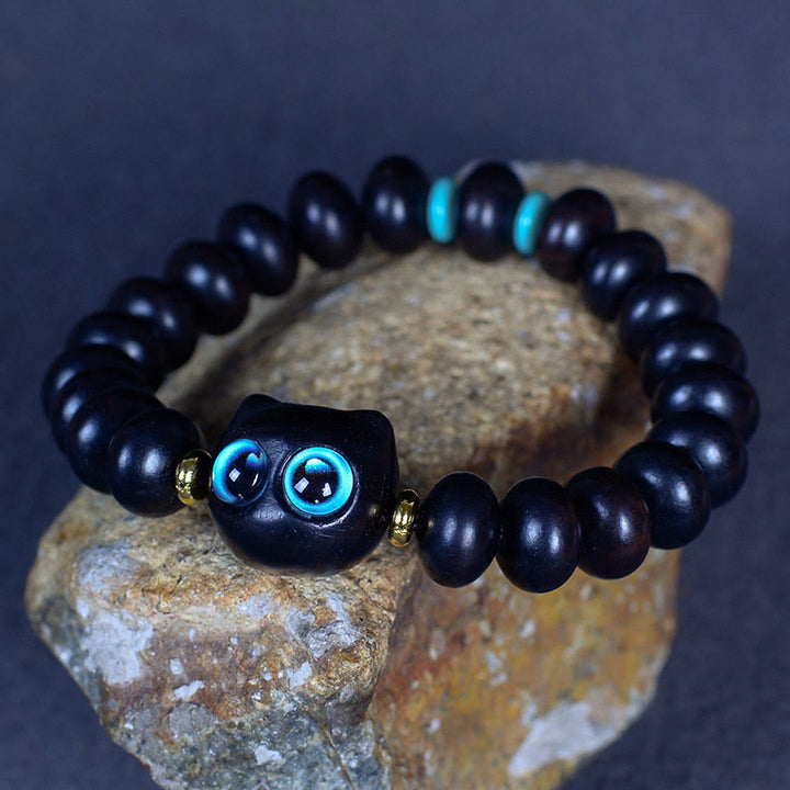 Armband Ebenholz Katze mit türkisen Augen elastisch schwarze Perlen