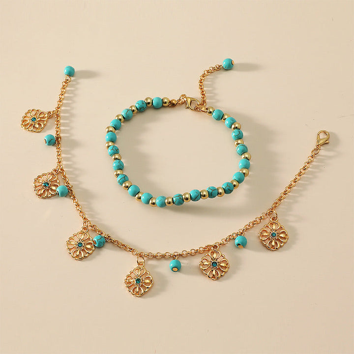 Armband Türkis – Schutz goldfarben mit Blumenanhängern elegant.
