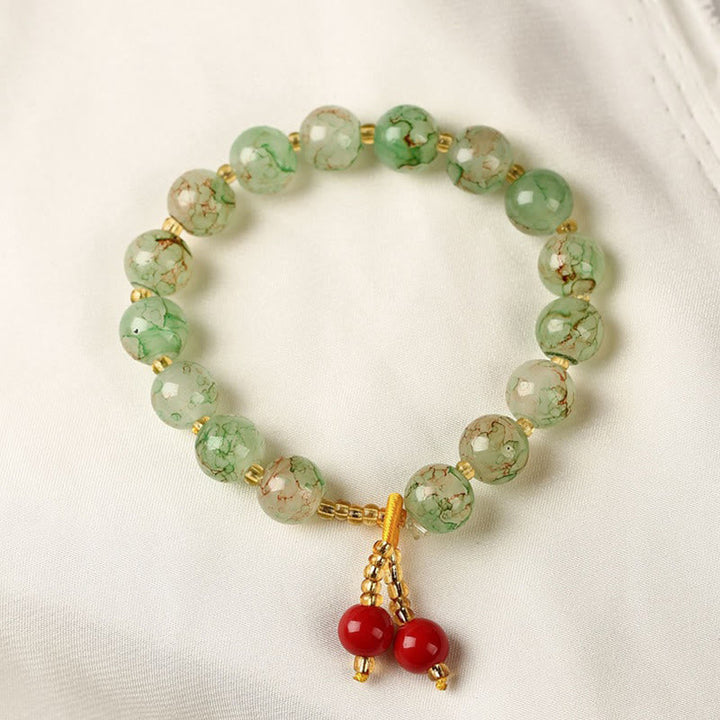 Armband – Harmonie & Segen grüne Jade Perlen rote Anhänger elegant
