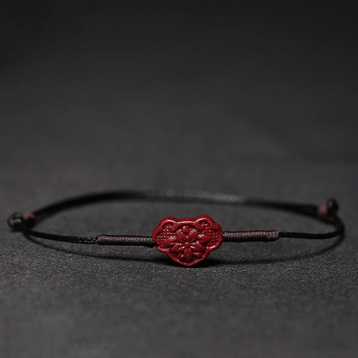 Rotes Herz Armband Zinnober Koi Fisch auf grauem Hintergrund Makro