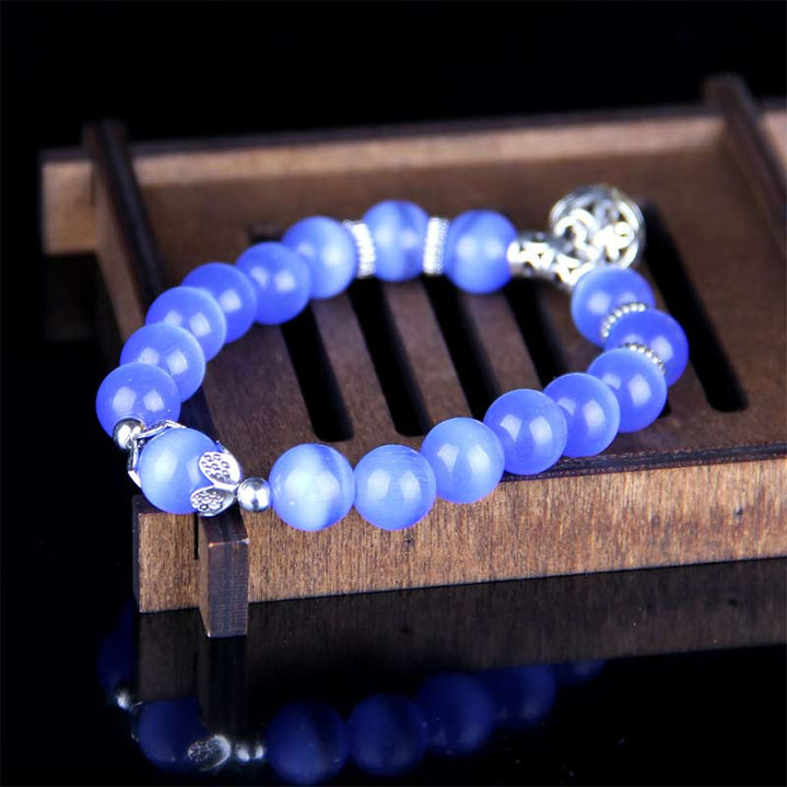 Blaues Chalcedon Armband mit Silber-Charm elegant präsentiert.