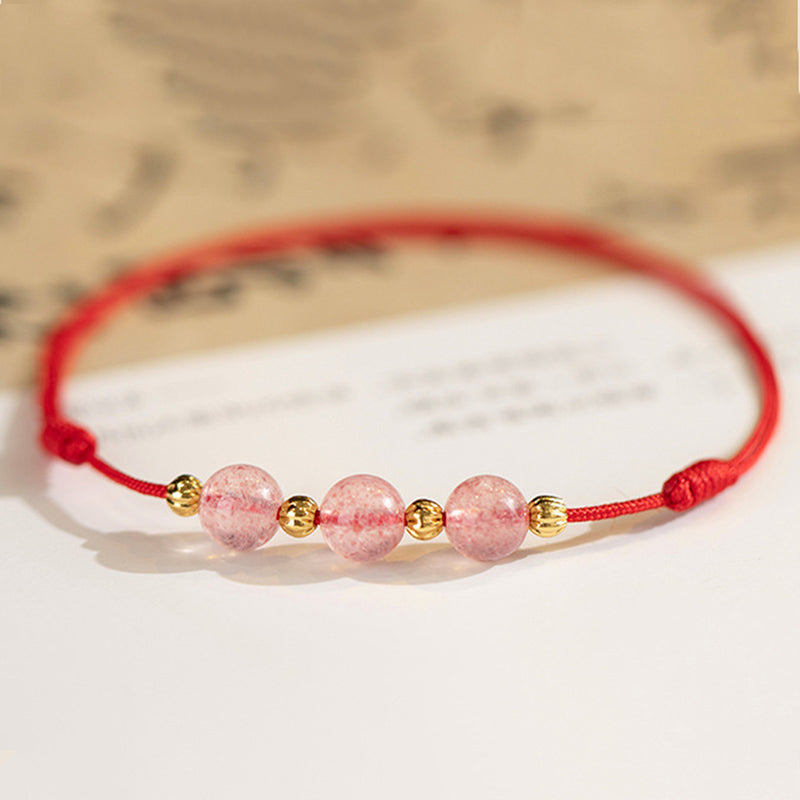 Armband Erdbeerquarz rosa Perlen goldene Akzente rotes Seidenband Glück Lebensfreude