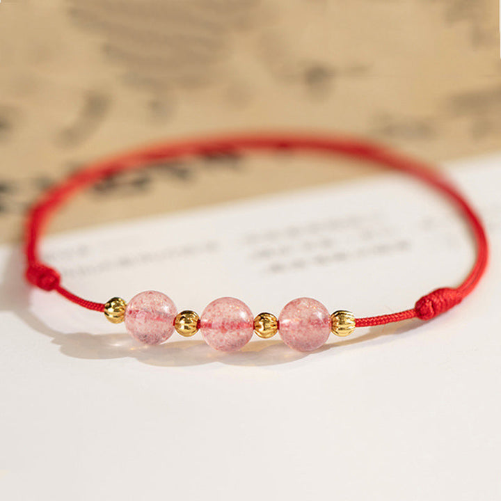 Armband Erdbeerquarz rosa Perlen goldene Akzente rotes Seidenband Glück Lebensfreude