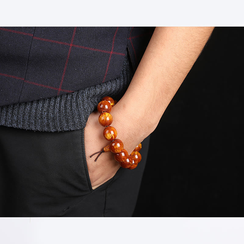 Mala – Erfolg Armband mit orangenen Perlen am Handgelenk getragen