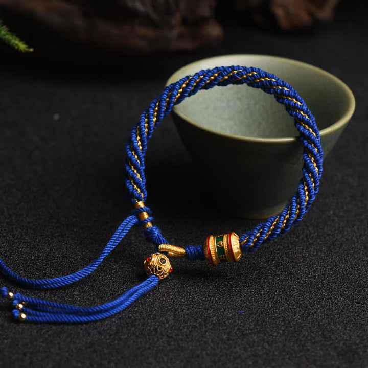 Blaues Tibet Gebet Rad Armband mit goldenen Perlen elastisch.
