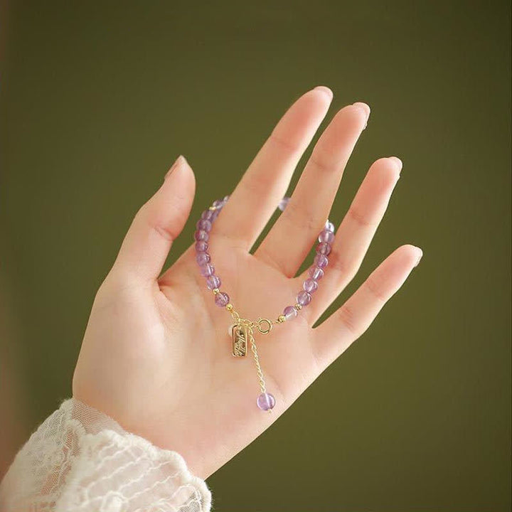 Armband Amethyst Kristall – Energie lila Perlen Goldverschluss Hand