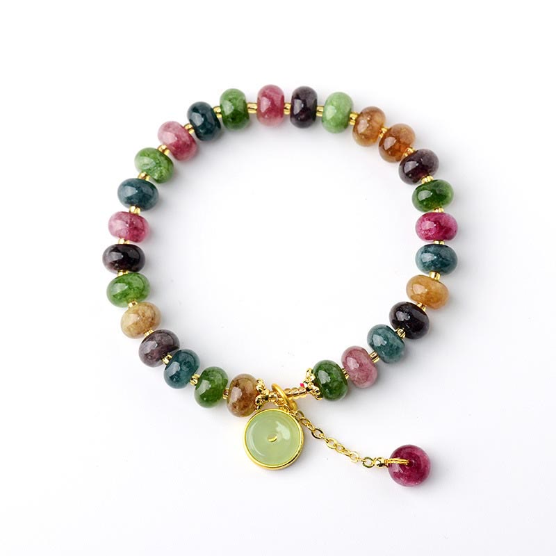Buntes Turmalin Armband mit Blütenanhänger elegant präsentiert.
