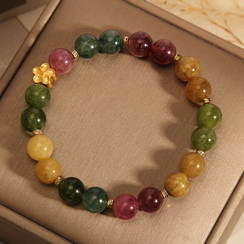 Buntes Tourmalin Armband mit goldener Blume Stein elastisch.