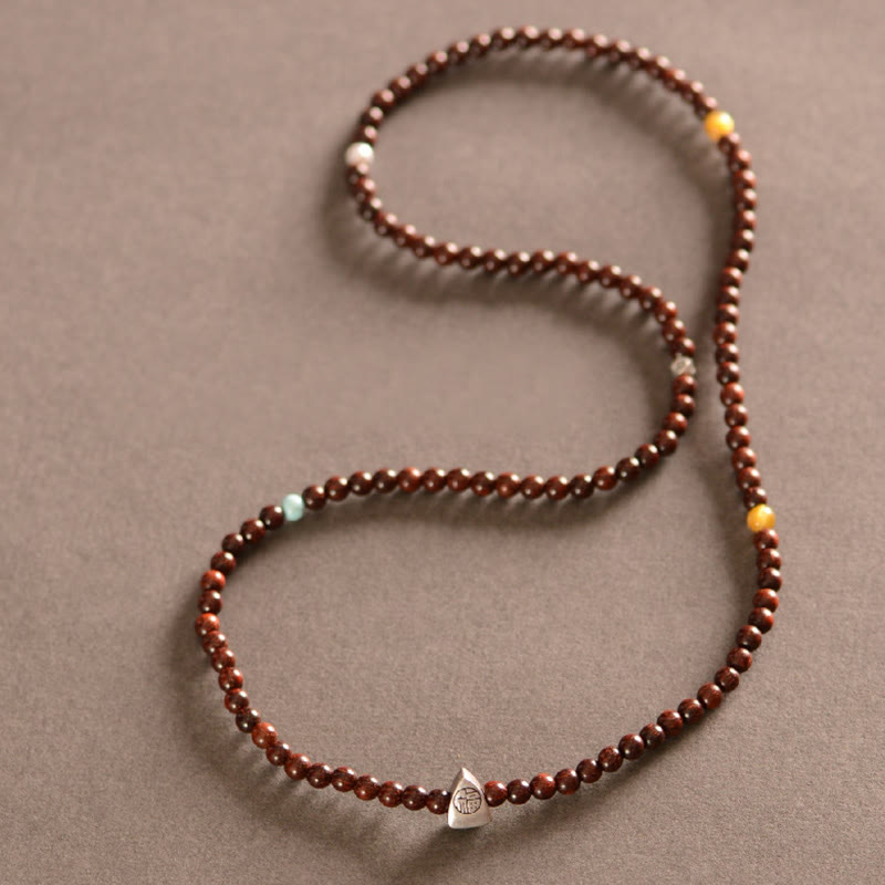 Sandelholz Armband mit 925 Silber Fu-Zeichen Anhänger, braun, elastisch.