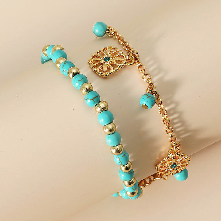 Armband Türkis – Schutz mit Gold-Details und Blütenanhängern