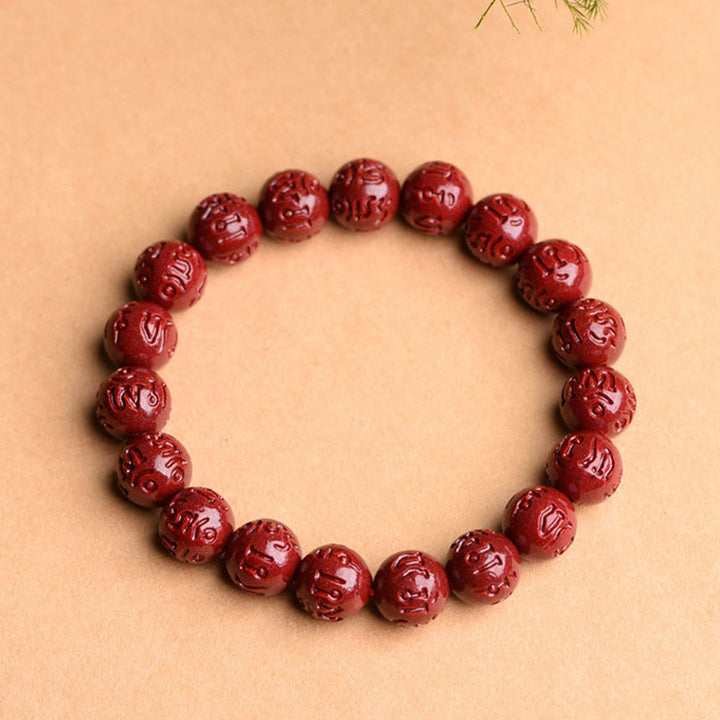 Rotes Armband mit Om Mani Padme Hum Gravur Zinnober elastisch