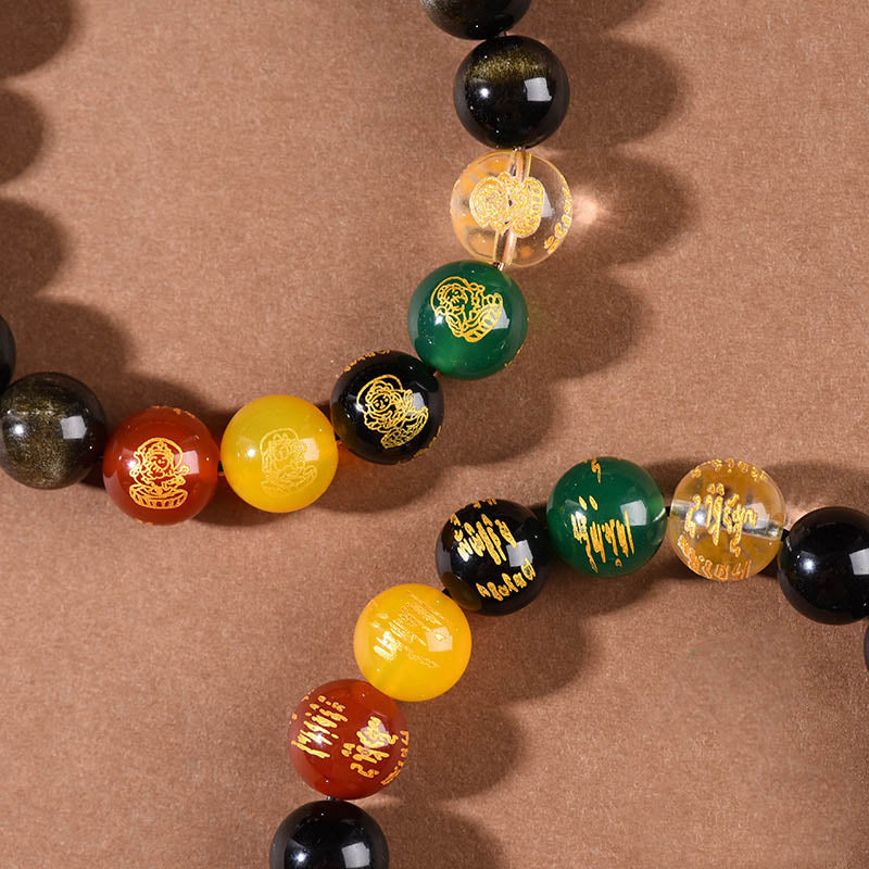 Armband Schwarzer Obsidian – Wohlstand mit farbigen Steinen auf Oberfläche.