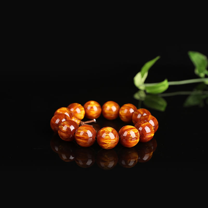 Mala – Erfolg Armband orange Perlen Naturstein glänzend schwarzer Hintergrund