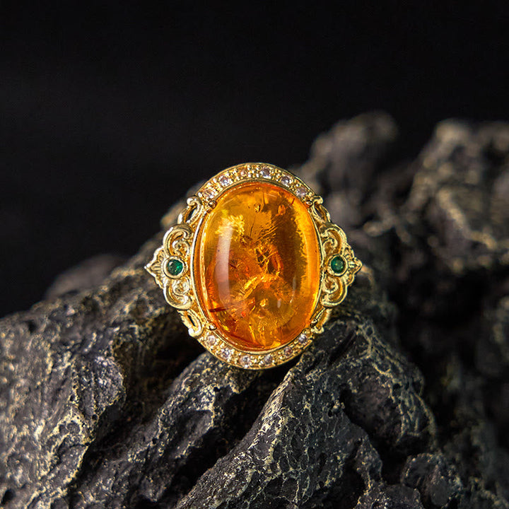 Ring Bernstein Blume Taubenmuster – Klarheit mit Goldbesatz und grünen Steinen
