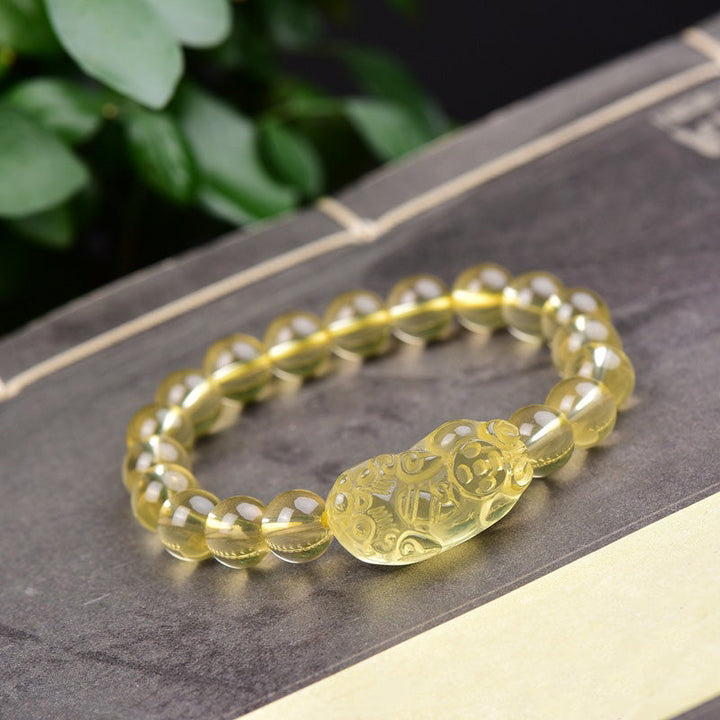 Armband Citrin Pixiu – Wohlstand mit gelbem Stein auf Slate-Oberfläche