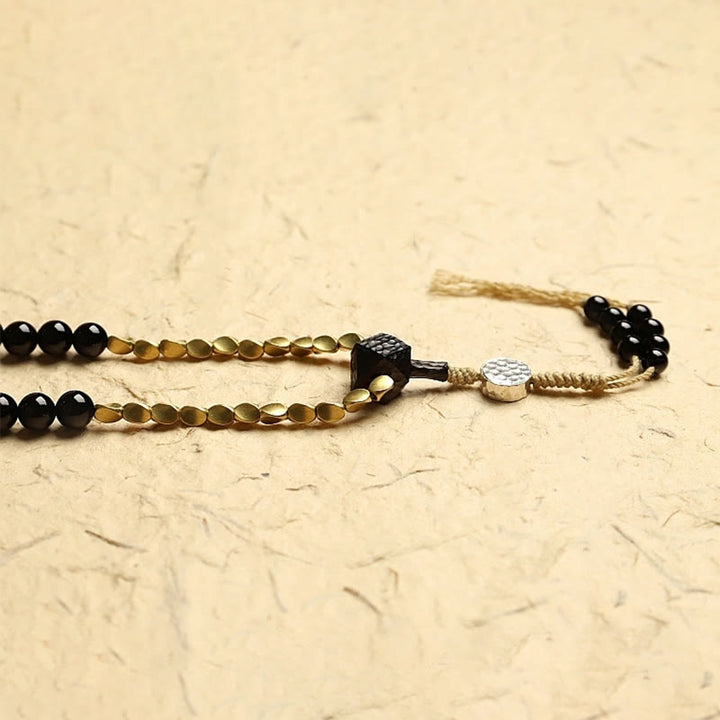 Mala Schwarzer Onyx Schutz Armband mit goldenen Perlen Quaste