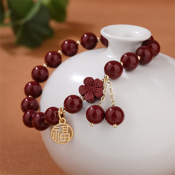 Armband Zinnober Fu-Zeichen Segen Energie rote Perlen Blütenanhänger Gold.