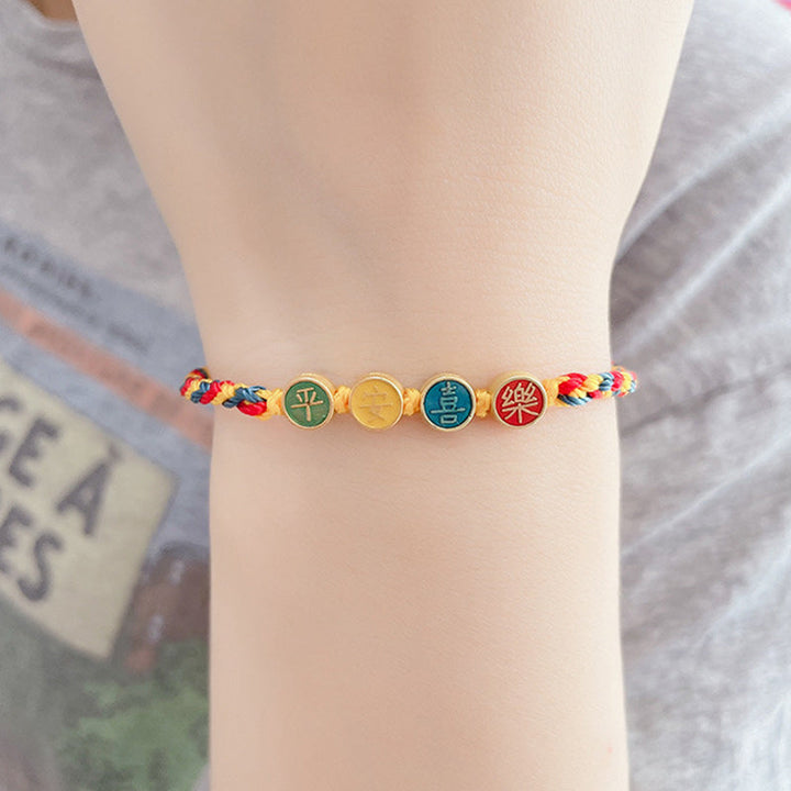 Armband – Schutz & Frieden mit bunten Schnüren und goldenen Charms Handgelenk.
