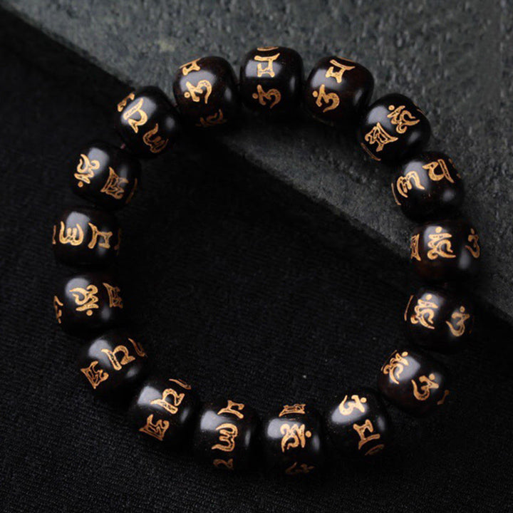Schwarzes Ebenholz Armband mit goldenen Om Mani Padme Hum Symbolen, Perlenarmband