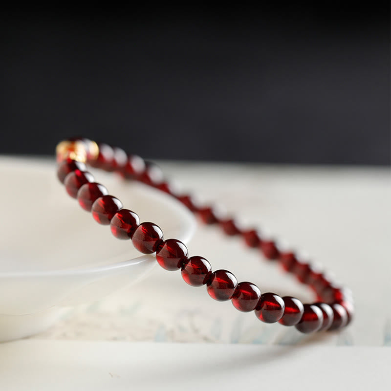 Rotes Granat Armband mit glänzenden Perlen elegant präsentiert Naturstein