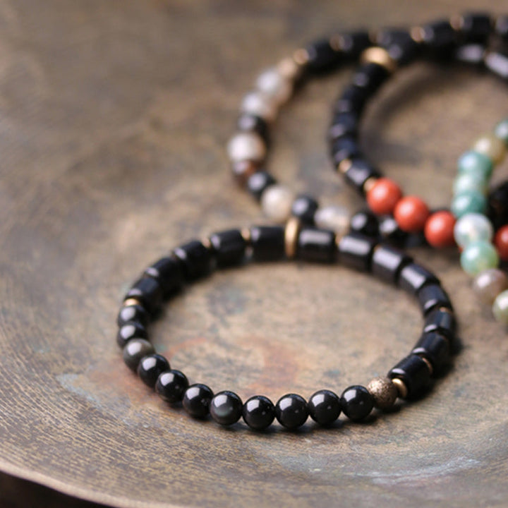 Schwarze Kristall Armbänder mit Kupfer Perlen elastisch Paar.