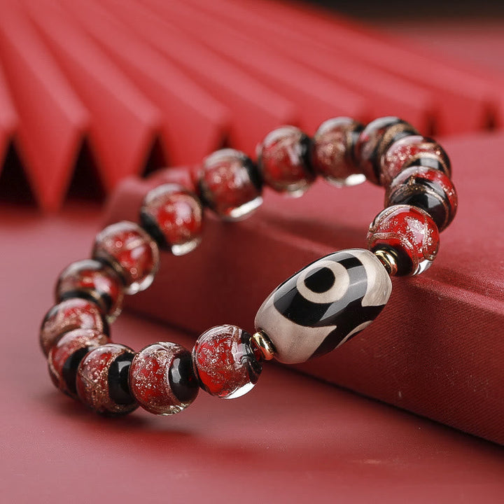 Armband – Wohlstand Balance rotes Glas elastisch mit silbernem Anhänger