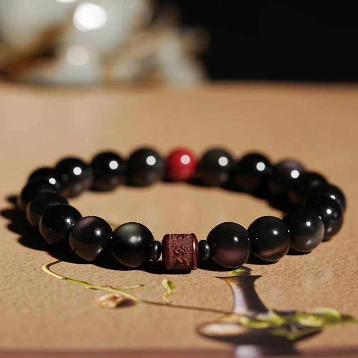 Schwarzes Obsidian Armband mit roten Perlen Heilstein Schmuck elegant.
