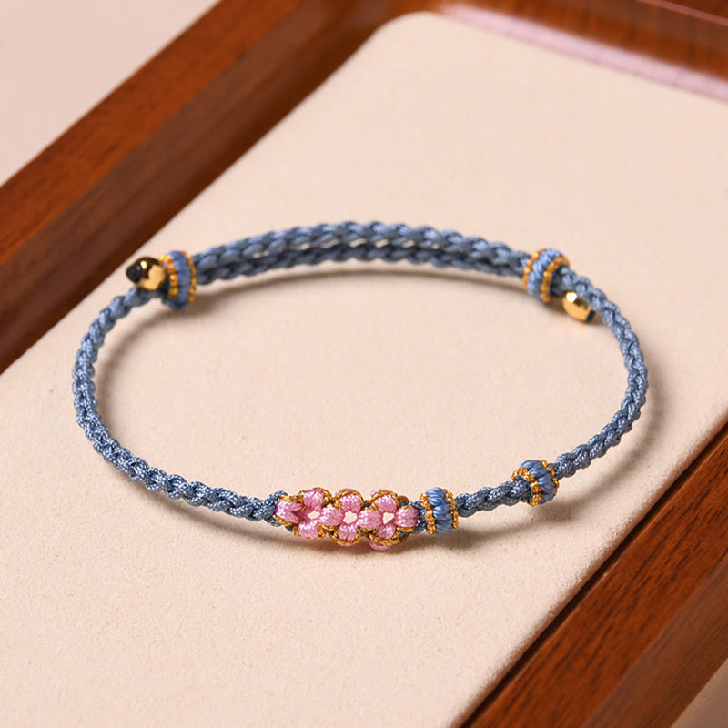 Armband Pfirsichblüte – Schutz blaues Seil rosa Perlen golden