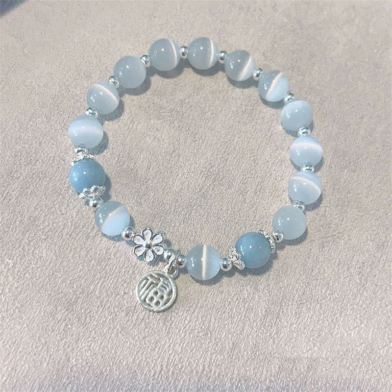 Hellblaues Kristall Armband Pfirsichblüte mit silbernen Perlen Blumenmotiv