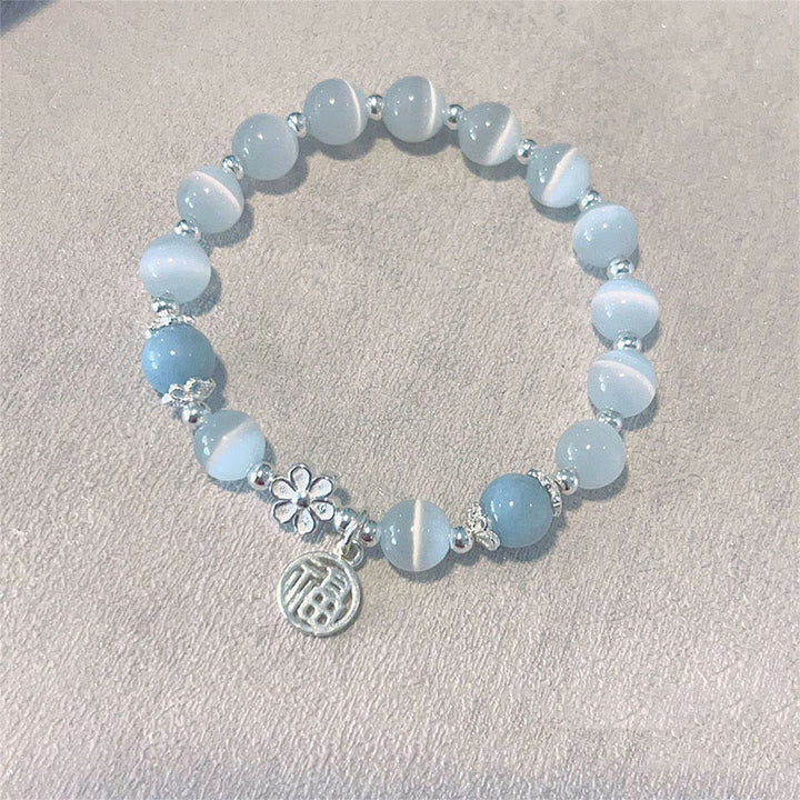 Hellblaues Kristall Armband Pfirsichblüte mit silbernen Perlen Blumenmotiv