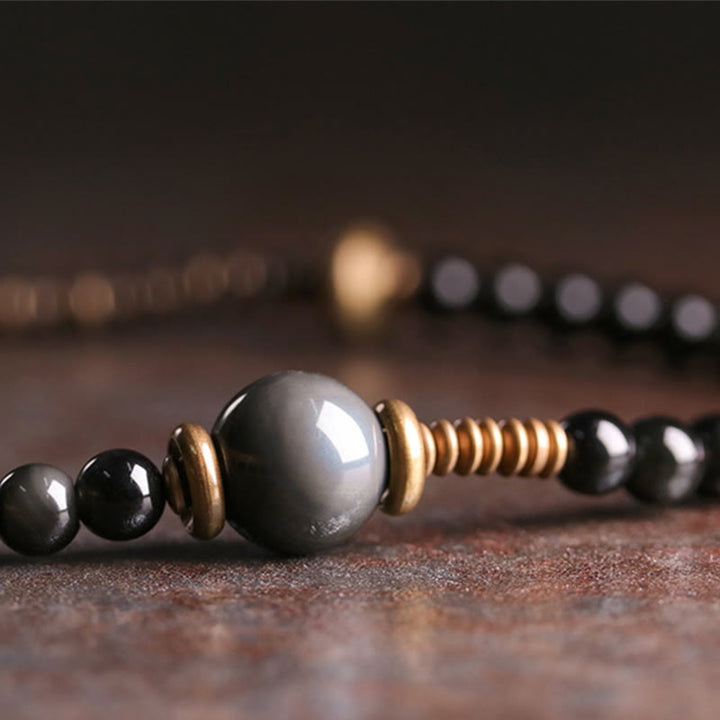 Armband Obsidian Kupfer mit schwarzen Perlen und Metallakzenten elegant.