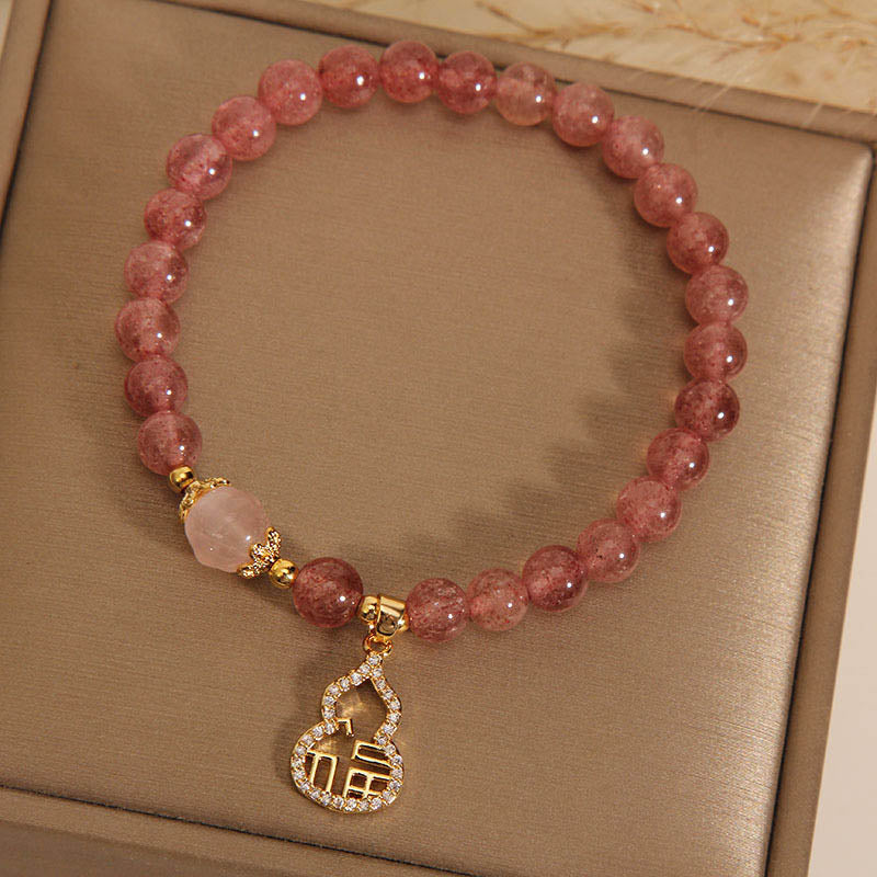 Armband Erdbeerquarz Fu-Zeichen rosé Perlen goldene Verschlüsse elegant.