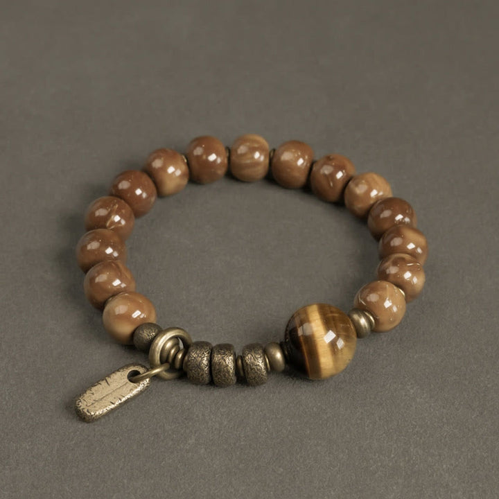 Armband Tigerauge Obsidian mit bronzefarbenen Perlen und Metallakzenten.